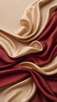 A flowing silk fabric in deep red and gold tones drapes softly, setting a calm and minimalist atmosphere with space for text. photo
