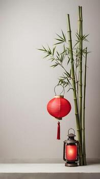 A sophisticated design with a few bamboo stalks and a red lantern, placed on a gentle, muted background, with room for branding or a message. photo