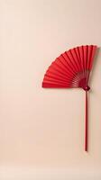 A minimalist design of a red paper fan on a light cream-colored background, offering space for logos or text. photo