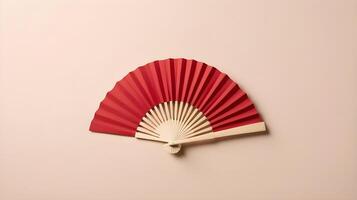 A clean, simple red fan against a smooth cream-colored backdrop, offering ample space for a logo or text. photo