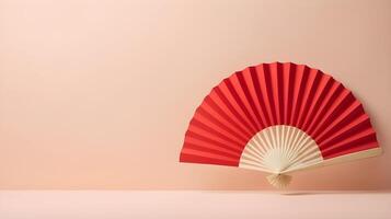 A minimalist red paper fan placed against a soft cream backdrop, with plenty of empty space for text or a logo. photo