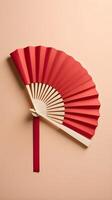 a simple, elegant red paper fan against a soft cream-colored background, with minimal detail and space for text or a logo. photo