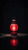 a serene scene featuring a single red lantern reflected on a smooth, dark surface. The background should have room for text above or below the lantern. photo