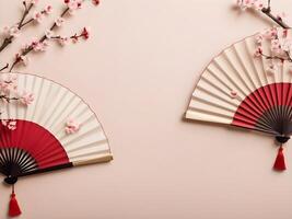 A decorative Chinese fan with cherry blossoms, set on a soft, subtle-colored background in shades of beige and light red, with space for text. photo