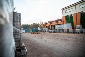 Construction Site with Partially Built Structure and Red Roof photo