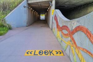 bike trail and creek go through underpass photo