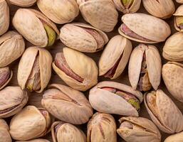 pistachio nuts arranged neatly, showcasing their textured shells and vibrant green kernels. photo