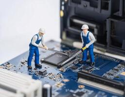 Miniature Technicians Toy Workers Repairing a Computer Keyboard photo