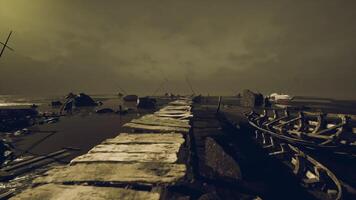 Dark coastal pier at sunset with boats and moody clouds video