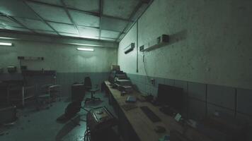 A dimly lit abandoned room with scattered items and disarrayed furniture video