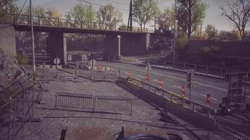 Construction area with barriers and a bridge in a quiet urban setting video