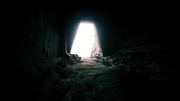 Light emerges from dark tunnel in abandoned structure at sunset video