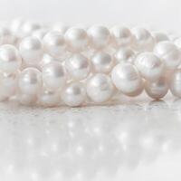 Nature white string of pearls on marble background in soft focus photo