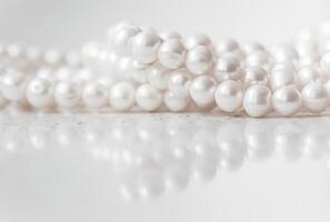 Nature white string of pearls on marble background in soft focus photo