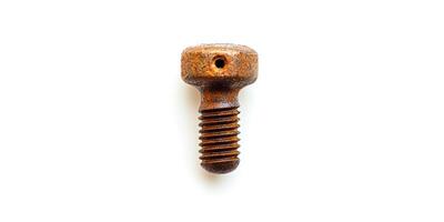 A rusted screw is sitting on a white background photo