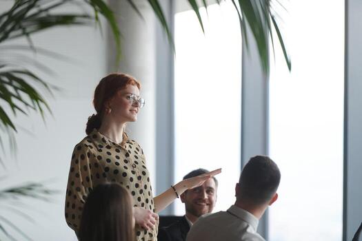 A diverse multiethnic business team engages in a collaborative meeting, discussing strategies and solutions in a modern office setting photo