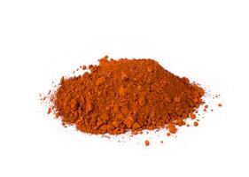 English Red. Bright Red Spice Heaped on a Clean Surface With a Scoop Showing Texture and Color Variation photo
