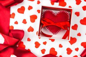 background to Valentine's Day or romantic event. heart in the gift box against the background of the hearts. photo
