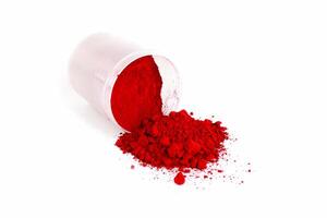 Vibrant Red Powder Spills From a Container on a White Surface During Crafting photo