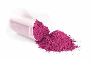Bright Pink Powder Spills From Glass Container on White Background During Art Project Preparation photo
