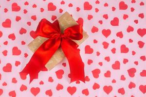 Valentine's Day. Presented as a red ribbon on a pink paper with red hearts photo