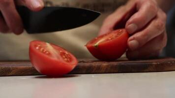 Close Up of Hands Slicing a Fresh Red Tomato on Wooden Cutting Board video