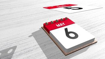 Close up of May month calendar with individual sheets flying upwards on a white wooden table with copy space. 3D Animation video