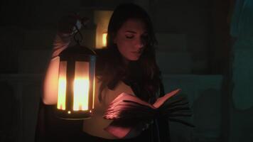 Woman Reads A Mysterious Book In A Crypt With A Medieval Lantern video