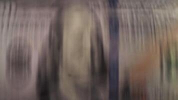 Close-up view of blurred currency notes on a flat surface video