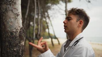 Technician Talks To The Trunk Of A Tree Like A Crazy Person In The Park video