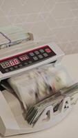 Money counting machine in action at a financial office setting video