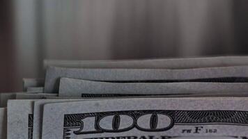Close up of stacks of hundred dollar bills in dim light setting video