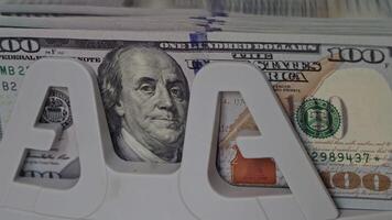 Currency display with a hundred dollar note highlighted on a stack video