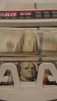 Currency being counted in a cash counting machine in a busy location video
