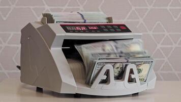 Currency counting machine in action with stacks of money video