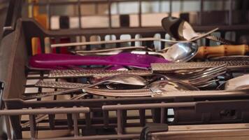Composed stack of clean utensils drying in a dish rack at home video