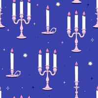 Seamless pattern with candles in chandeliers on a blue background. graphics. vector