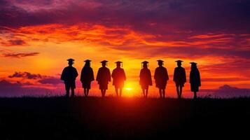 Silhouettes of Graduates at Sunset. photo