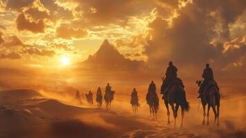 A Caravan of Camels Crossing the Desert at Sunset photo