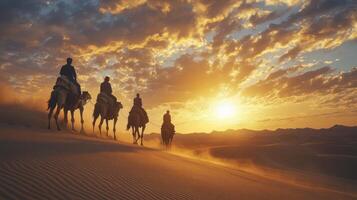 Camel Caravan Silhouetted Against a Sunset Sky in the Desert photo