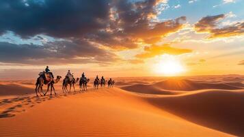 Camel Caravan Crossing Desert Dunes at Sunset photo