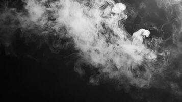 White Smoke Curls and Swirls Against Black Background photo