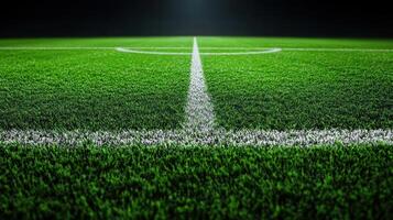 A close-up view of a white line on a green artificial turf field photo
