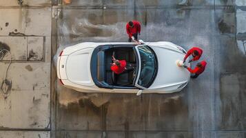 Aerial View of White Convertible Car Being Washed by Workers photo