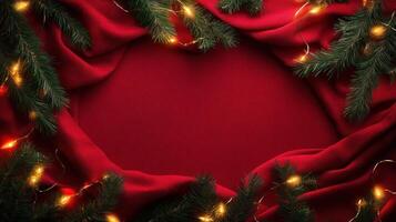 Pine Branches with Fairy Lights on Red Fabric Background photo