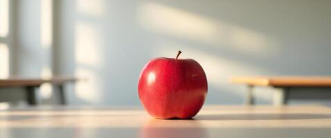 A Red Apple Sits On A Desk In A Classroom photo