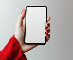 Hand holding a blank smartphone with a modern design in a minimalist setting photo