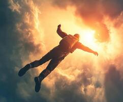 Skydiver performs a freefall jump through vibrant clouds against a dramatic sunset backdrop photo