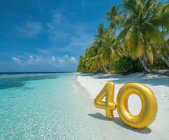 Golden number 40 displayed on a beautiful tropical beach with clear turquoise water and palm trees photo