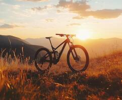 Mountain bike silhouette against a vibrant sunset in a grassy landscape, creating a tranquil outdoor setting photo
